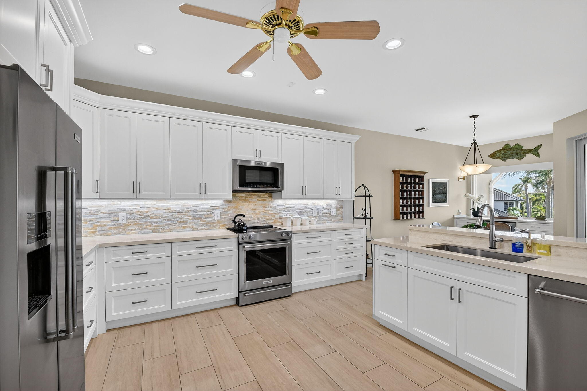 194 Orange Tree Drive, Unit G Atlantis, FL 33462 - Photo 11 of 36 a kitchen with cabinets stainless steel appliances and a counter space