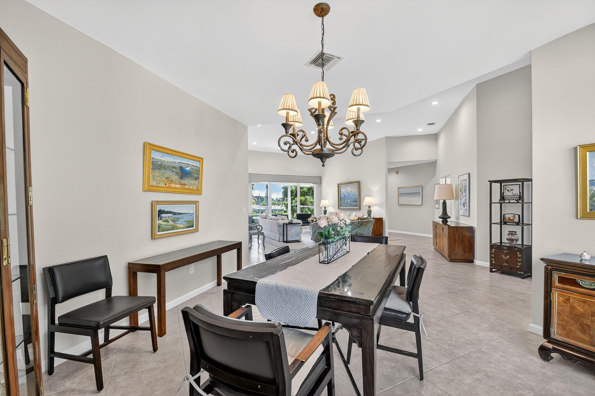 194 Orange Tree Drive, Unit G Atlantis, FL 33462 - Photo 18 of 36 a view of a dining room with furniture a chandelier and a window