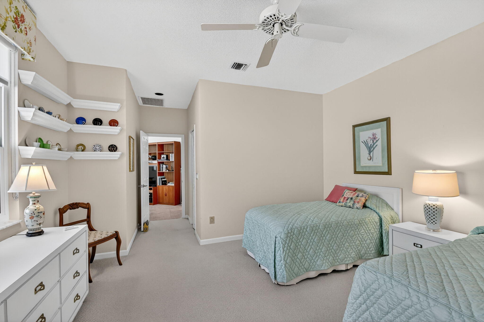 194 Orange Tree Drive, Unit G Atlantis, FL 33462 - Photo 22 of 36 a bedroom with a bed and a lamp on dresser