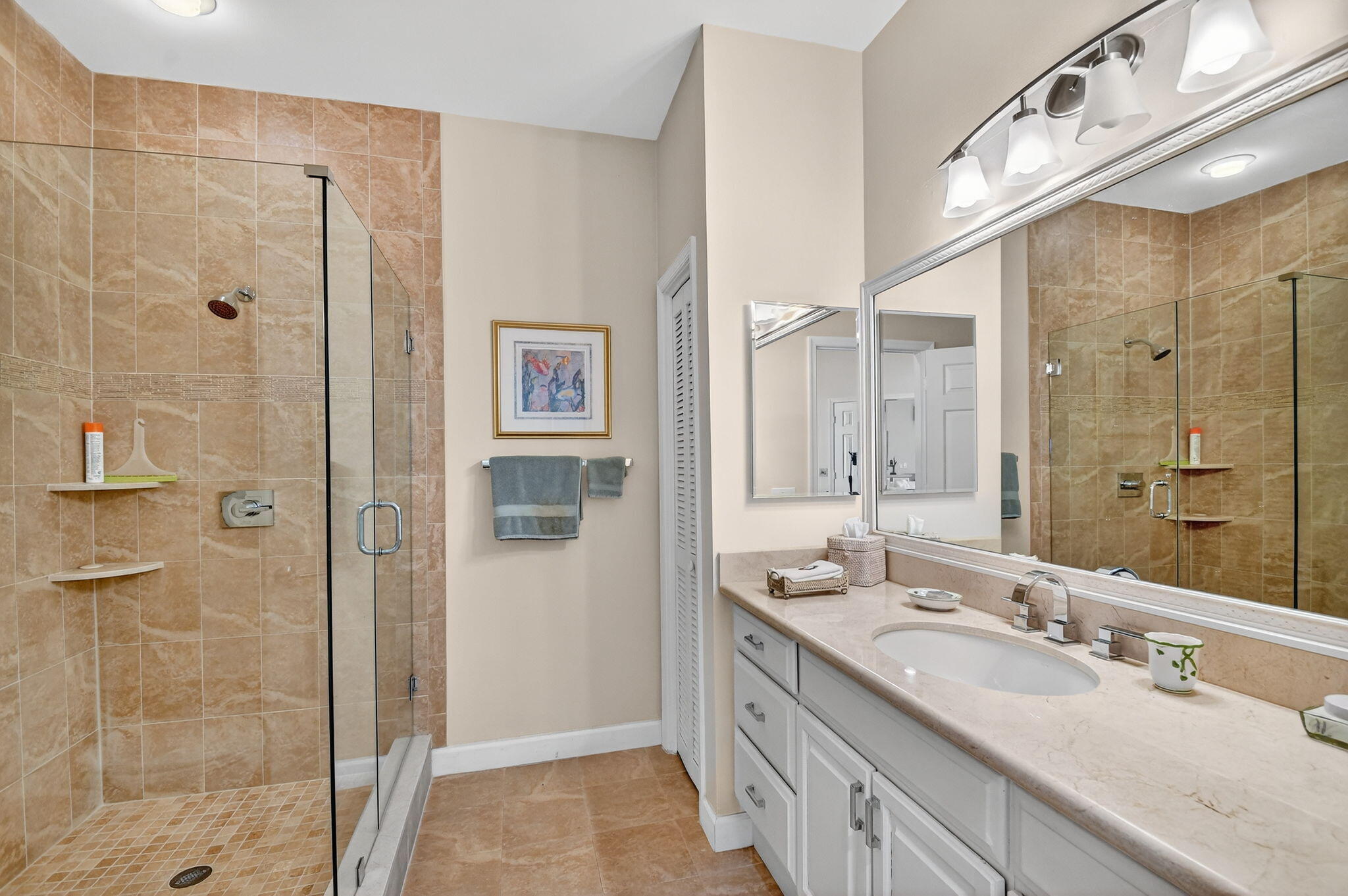 194 Orange Tree Drive, Unit G Atlantis, FL 33462 - Photo 23 of 36 a bathroom with a double vanity sink mirror and shower
