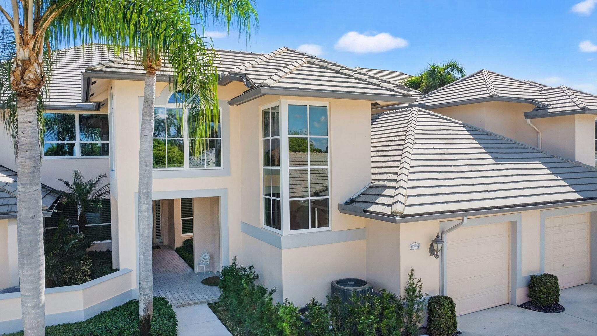 194 Orange Tree Drive, Unit G Atlantis, FL 33462 - Photo 35 of 36 a front view of a house with a yard