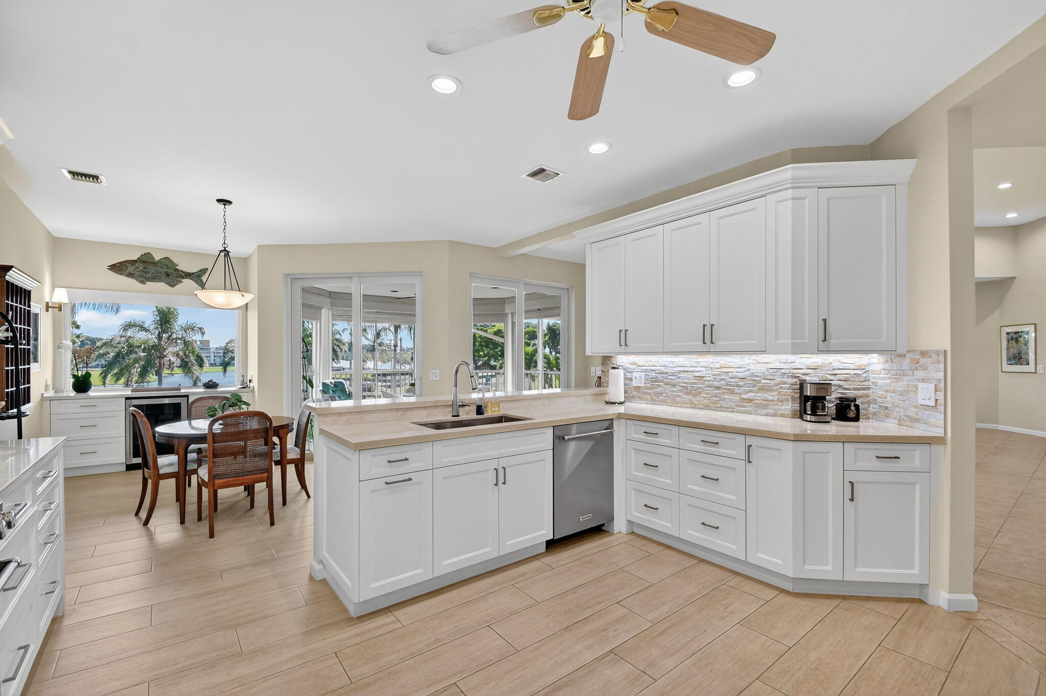 194 Orange Tree Drive, Unit G Atlantis, FL 33462 - Photo 10 of 36 a large white kitchen with a large window