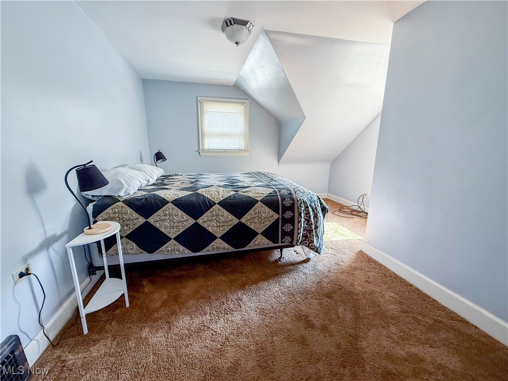 4672 Liberty Road South Euclid, OH 44121 - Photo 13 of 23 Carpeted bedroom with vaulted ceiling and baseboards