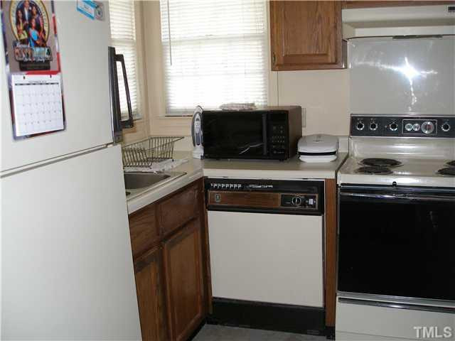 3316 Comstock Road Raleigh, NC 27604 - Photo 5 of 9 a kitchen with stainless steel appliances a stove a microwave and a refrigerator
