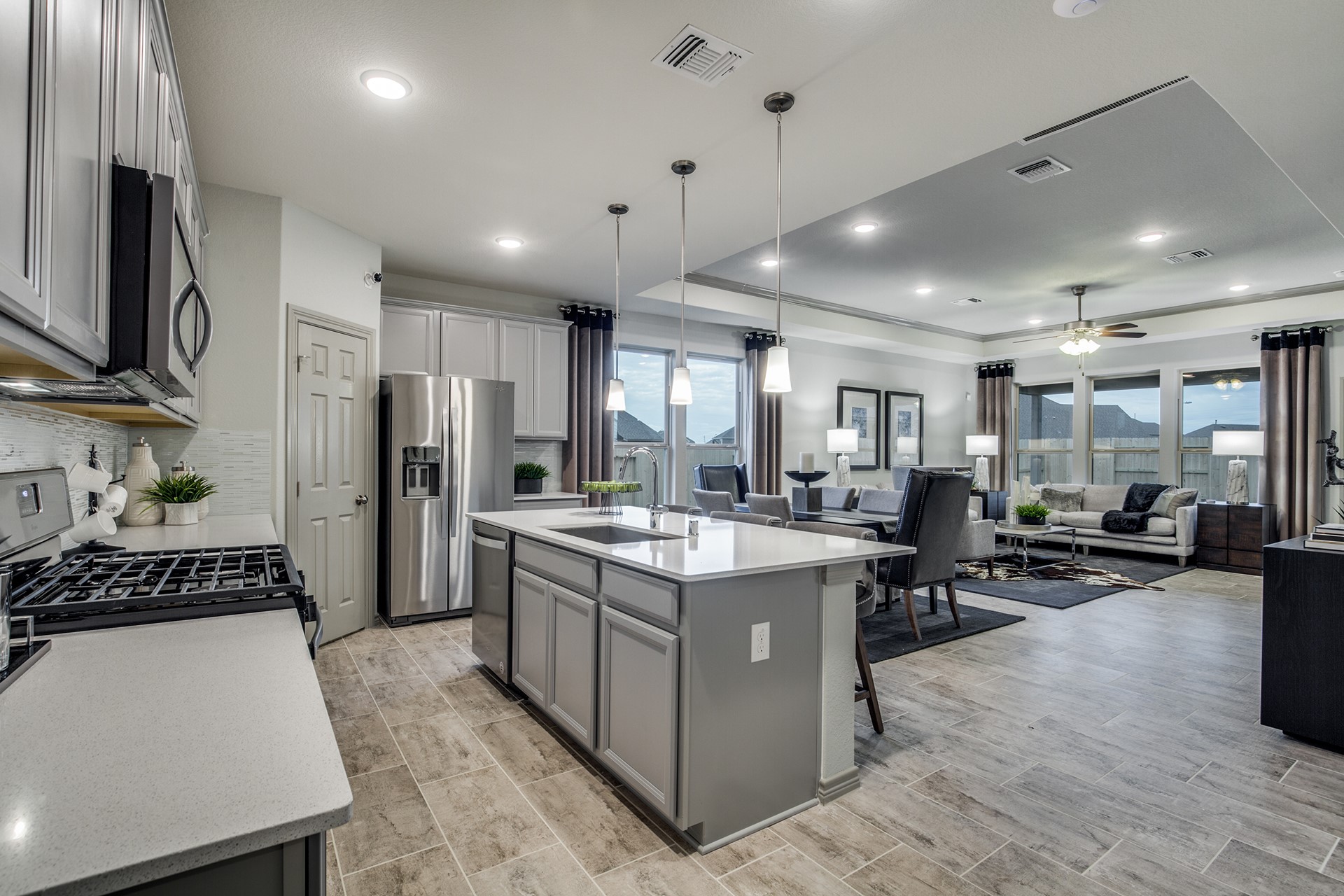 15638 Wandering Maple Way Conroe, TX 77302 - Photo 4 of 20 a kitchen with kitchen island a counter top space a sink stainless steel appliances and cabinets