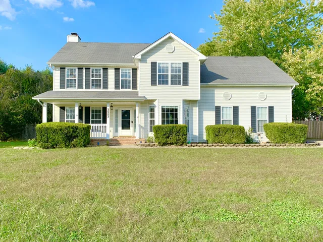 a front view of a house with a yard