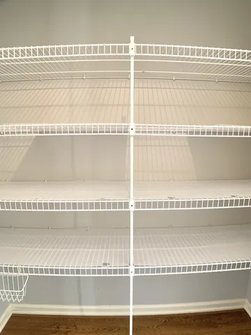 a view of a livingroom with wooden floor and a large window