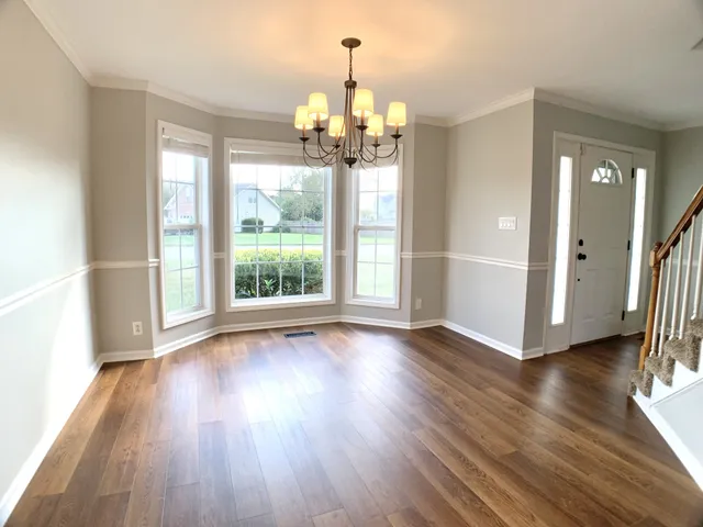 a view of front door and wooden floor