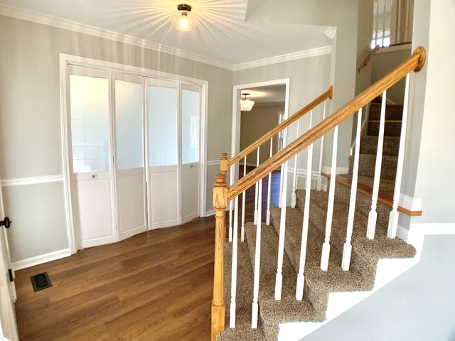 a view of a big room with wooden floor and windows in a room