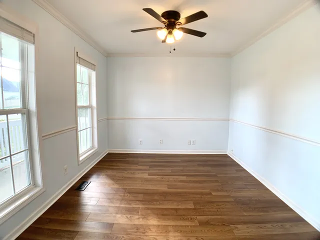 a view of a hallway with wooden floor and staircase