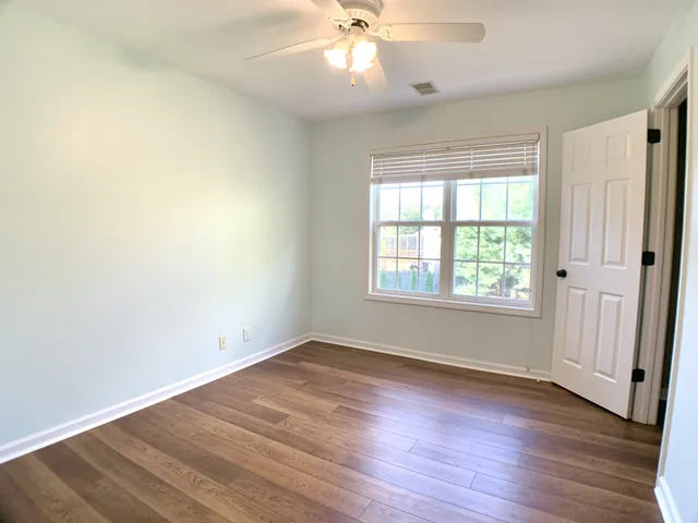 a bathroom with a sink a toilet a large mirror and shower