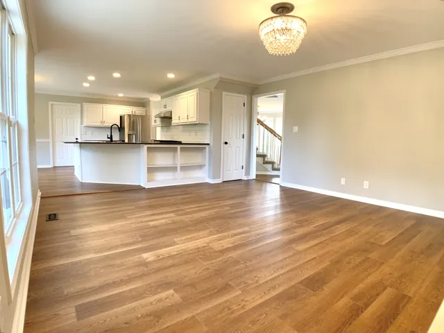 a kitchen with stainless steel appliances granite countertop wooden cabinets a sink dishwasher a stove and a refrigerator