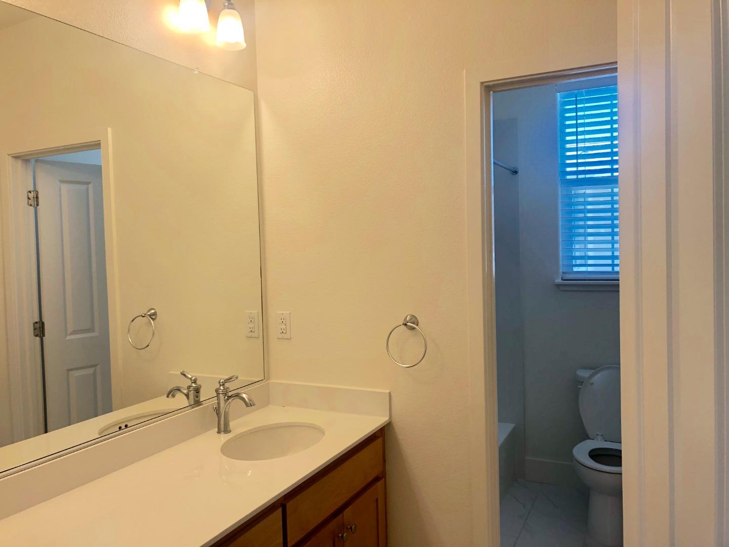 950 Puma Way Gilroy, CA 95020 - Photo 11 of 17 a bathroom with a sink and a mirror