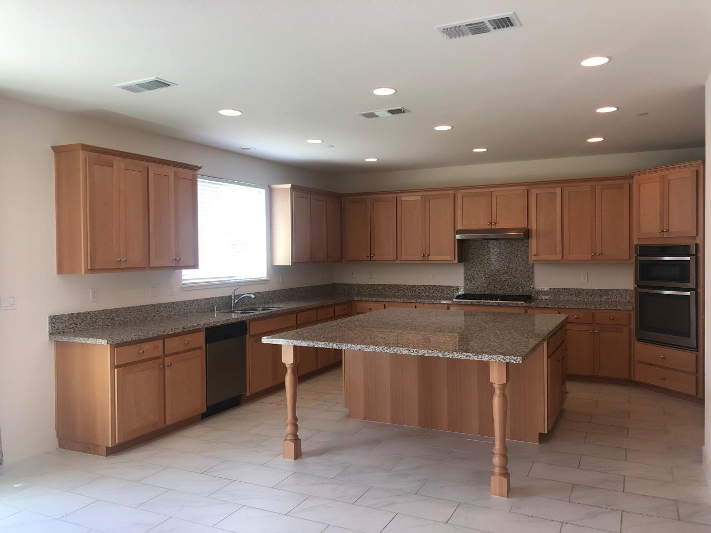 950 Puma Way Gilroy, CA 95020 - Photo 3 of 17 a kitchen with granite countertop sink window and chairs