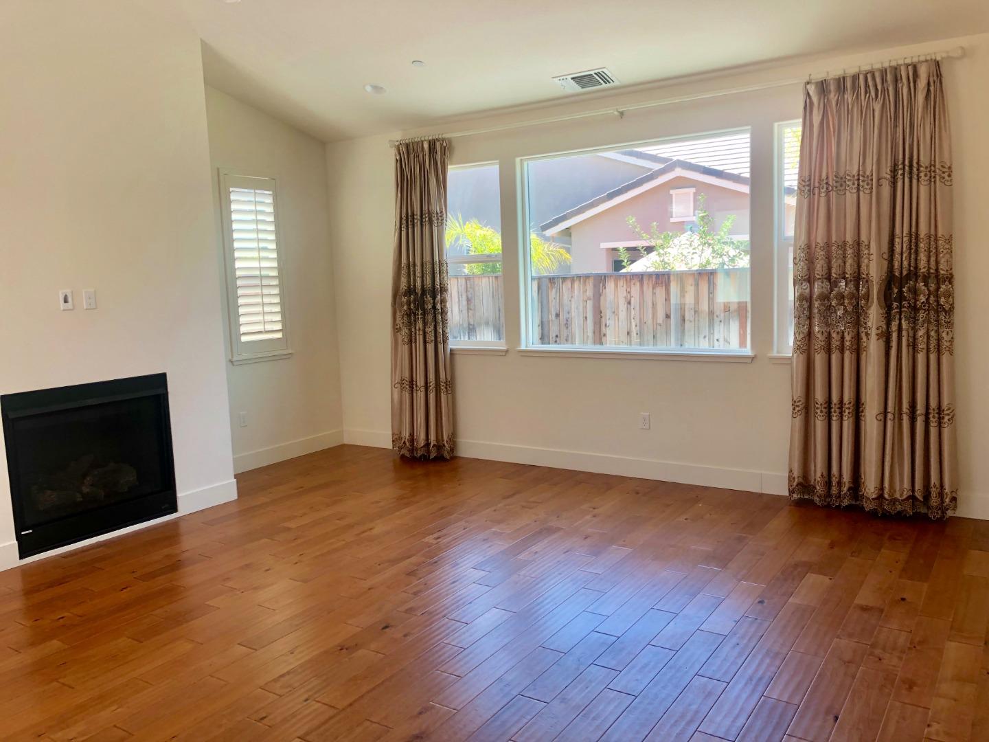 950 Puma Way Gilroy, CA 95020 - Photo 5 of 17 an empty room with wooden floor and windows