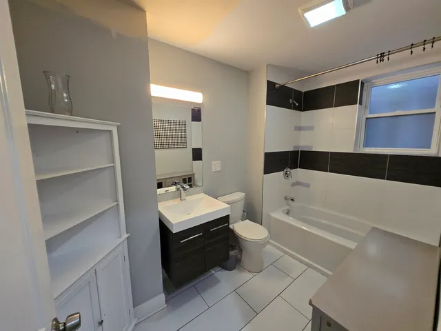 a bathroom with a toilet a sink and bathtub