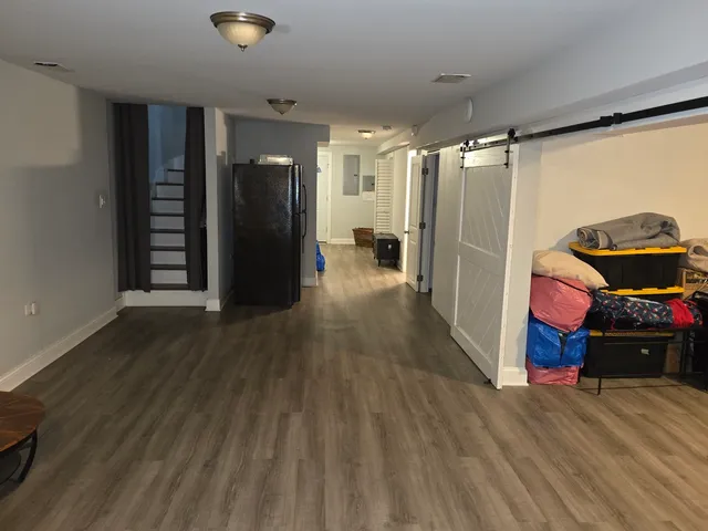 a view of a room with wooden floor