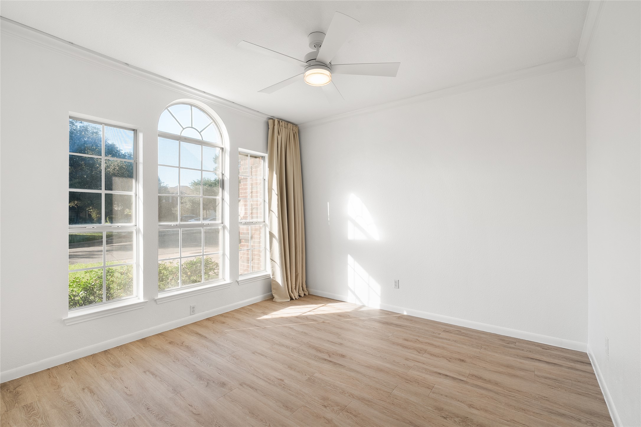 206 River Down Road Georgetown, TX 78628 - Photo 6 of 39 Room featuring wood-finish flooring, a contemporary ceiling fan, and white crown molding