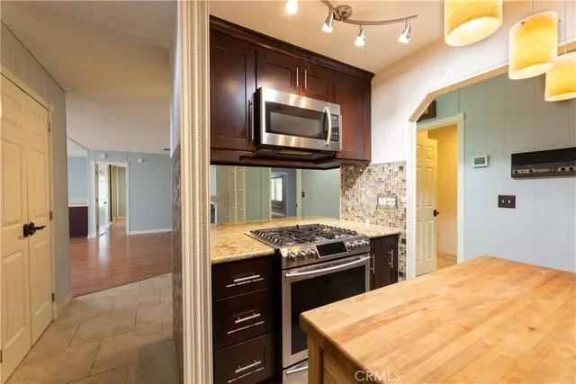 a kitchen with stainless steel appliances granite countertop a stove and a refrigerator
