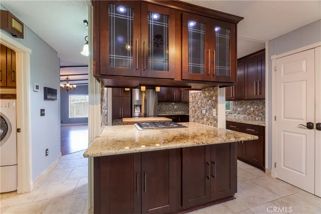 a kitchen with cabinets and chandelier