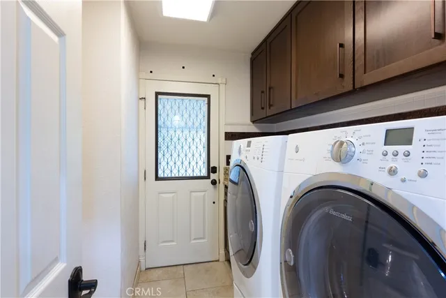 a view of washer and dryer with kitchen in the background