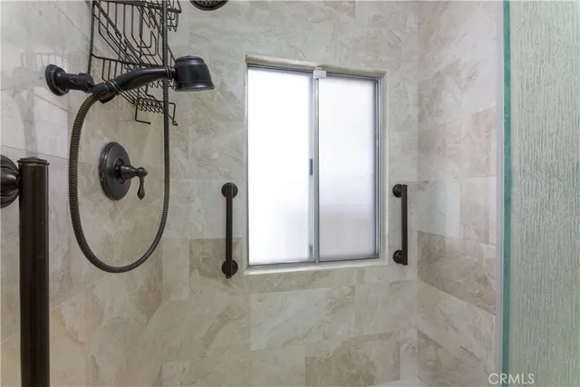 a view of a livingroom with wooden floor and a ceiling fan