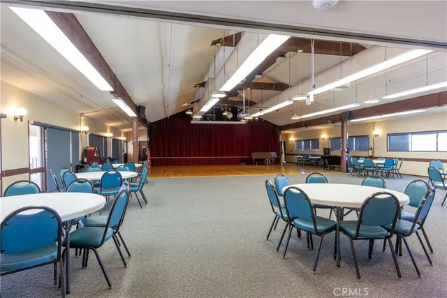a dining room with a wooden table and chairs