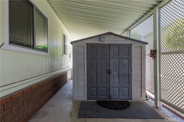 a view of a small house with wooden fence