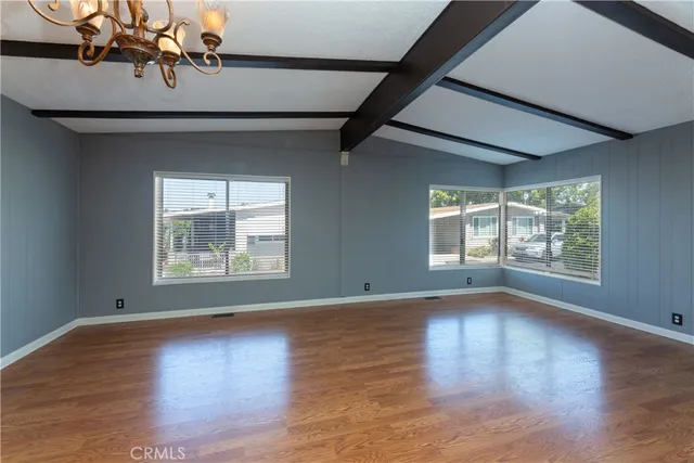a view of a livingroom with wooden floor and window