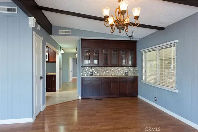 a view of an entryway with a fireplace and a chandelier