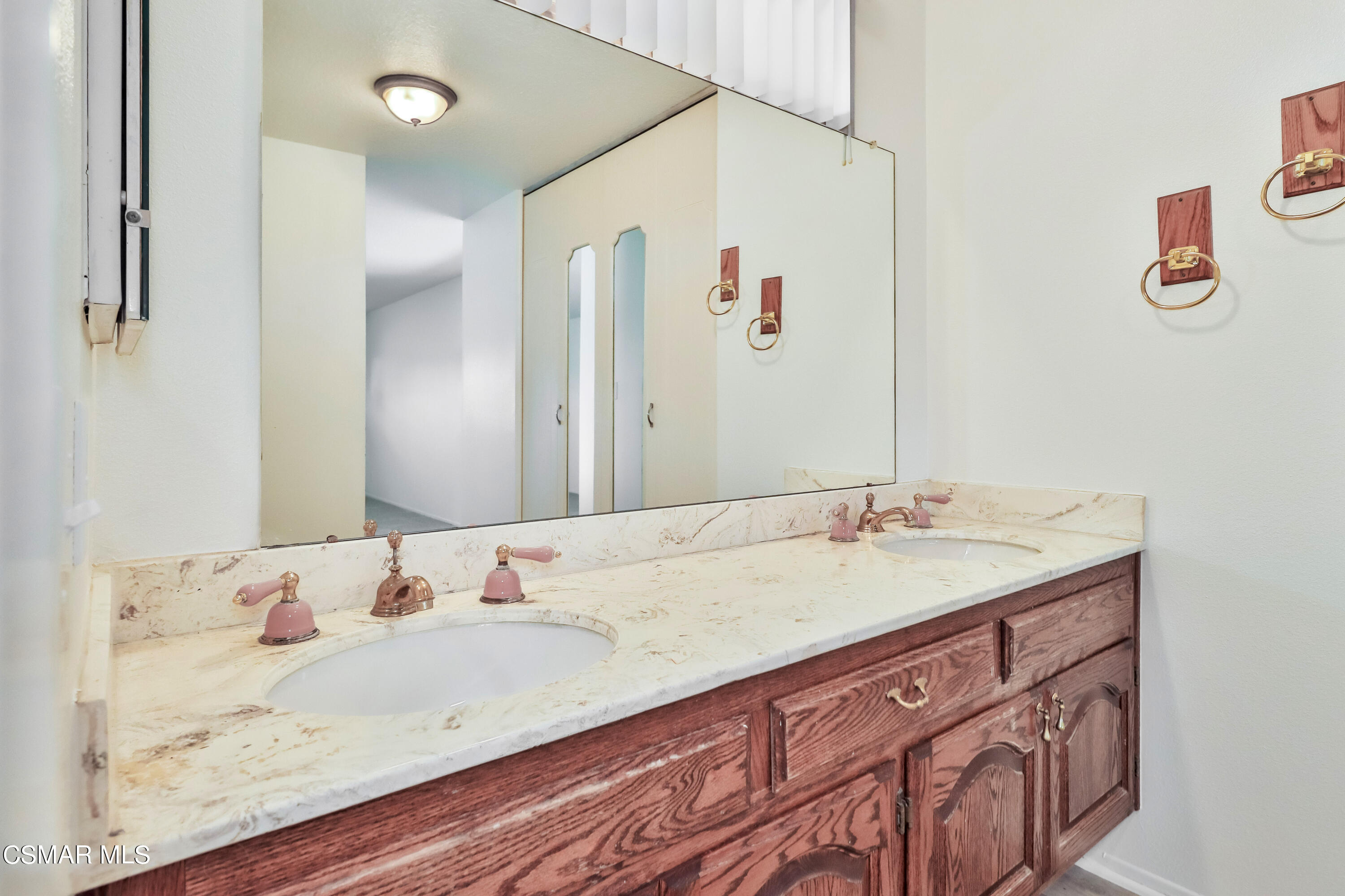 4220 Springfield Street Simi Valley, CA 93063 - Photo 77 of 95 a bathroom with a granite countertop sink and a mirror