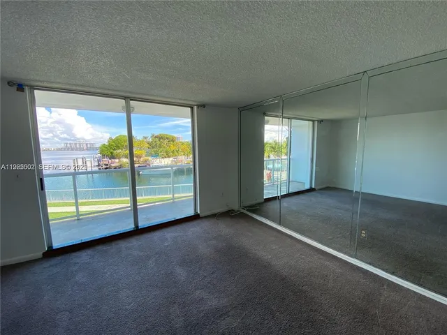 an empty room with an outdoor view and sliding door