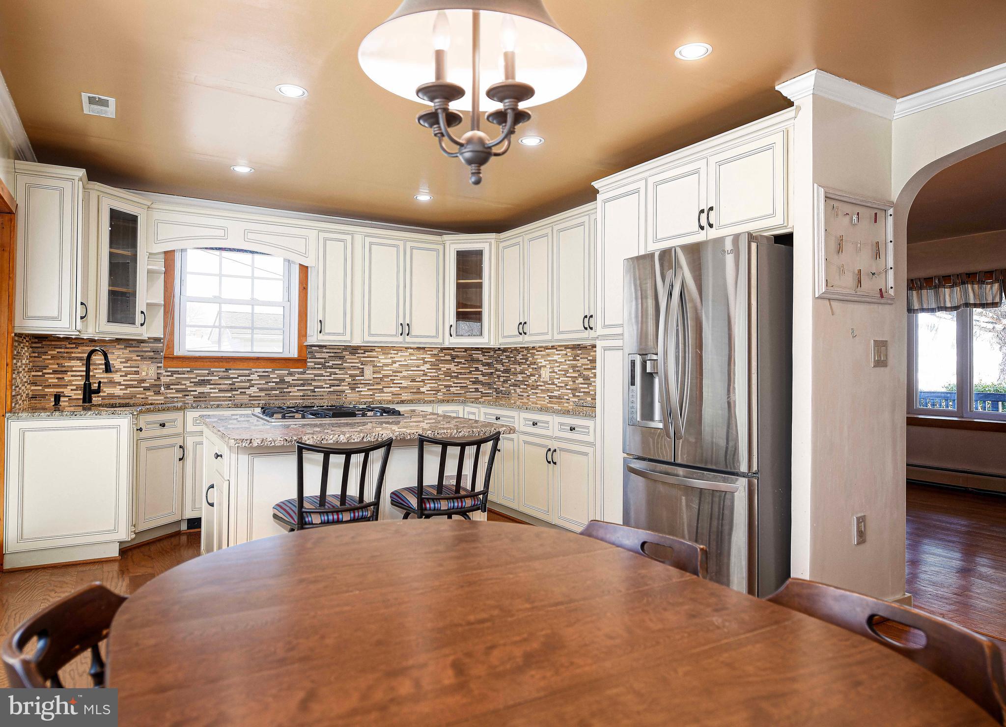 922 Rock Spring Road Bel Air, MD 21014 - Photo 15 of 69 a kitchen with stainless steel appliances granite countertop a refrigerator a sink a stove a dining table and chairs