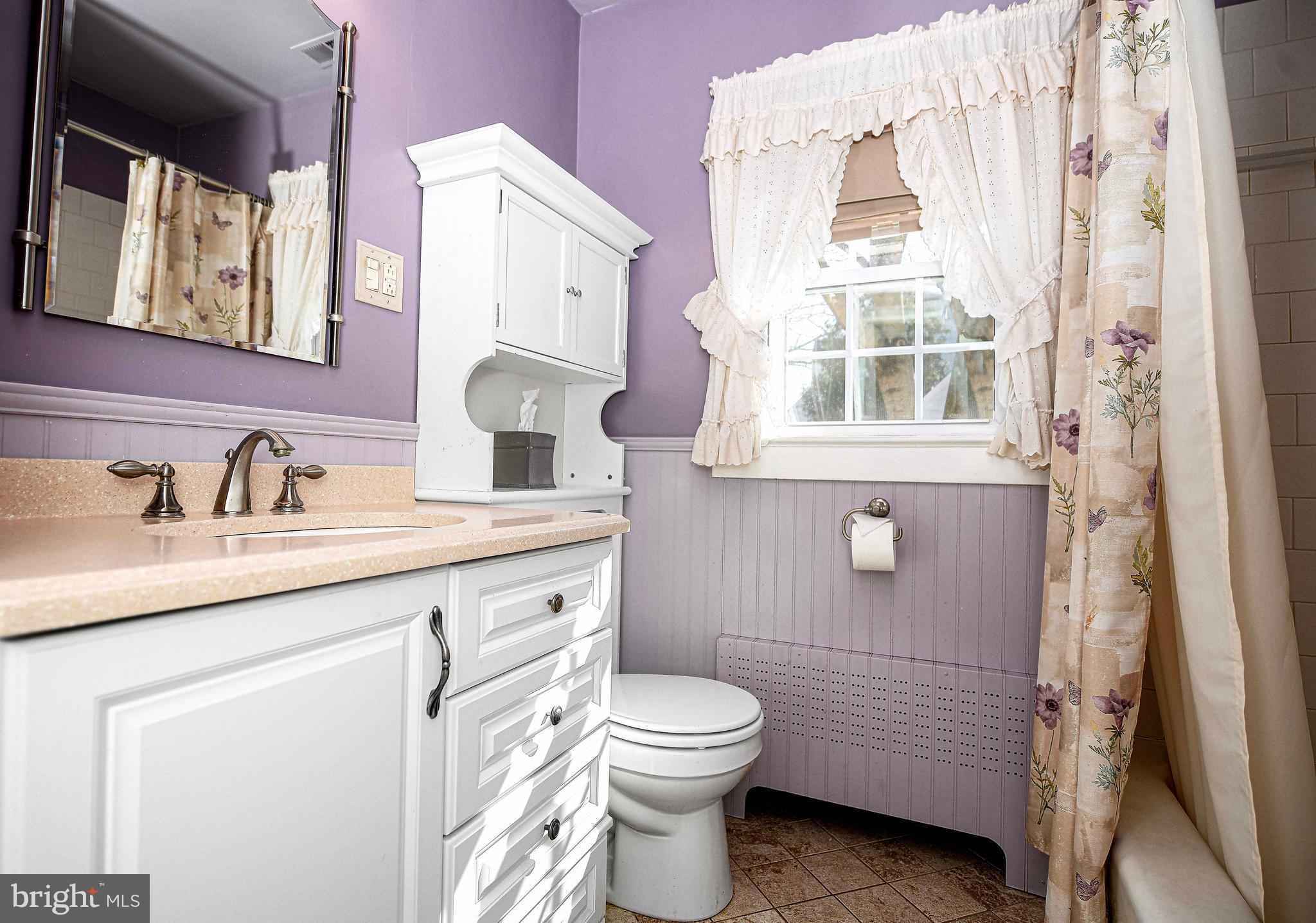 922 Rock Spring Road Bel Air, MD 21014 - Photo 24 of 69 a bathroom with a granite countertop toilet a sink a mirror and a window