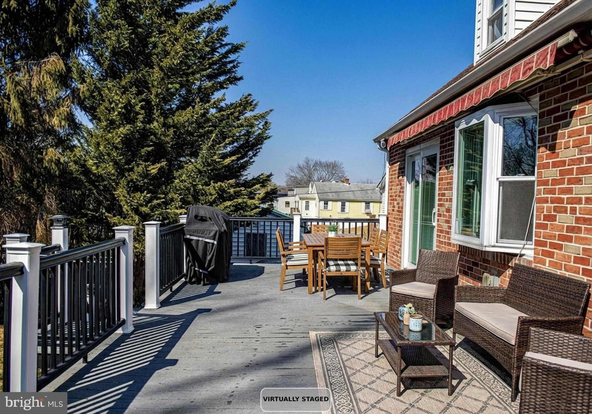 922 Rock Spring Road Bel Air, MD 21014 - Photo 32 of 69 a view of a patio with couches and table and chairs with wooden floor and fence
