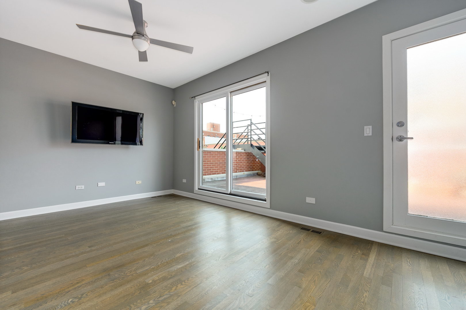 18 North Ada Street, Unit C Chicago, IL 60607 - Photo 25 of 28 an empty room with wooden floor and windows
