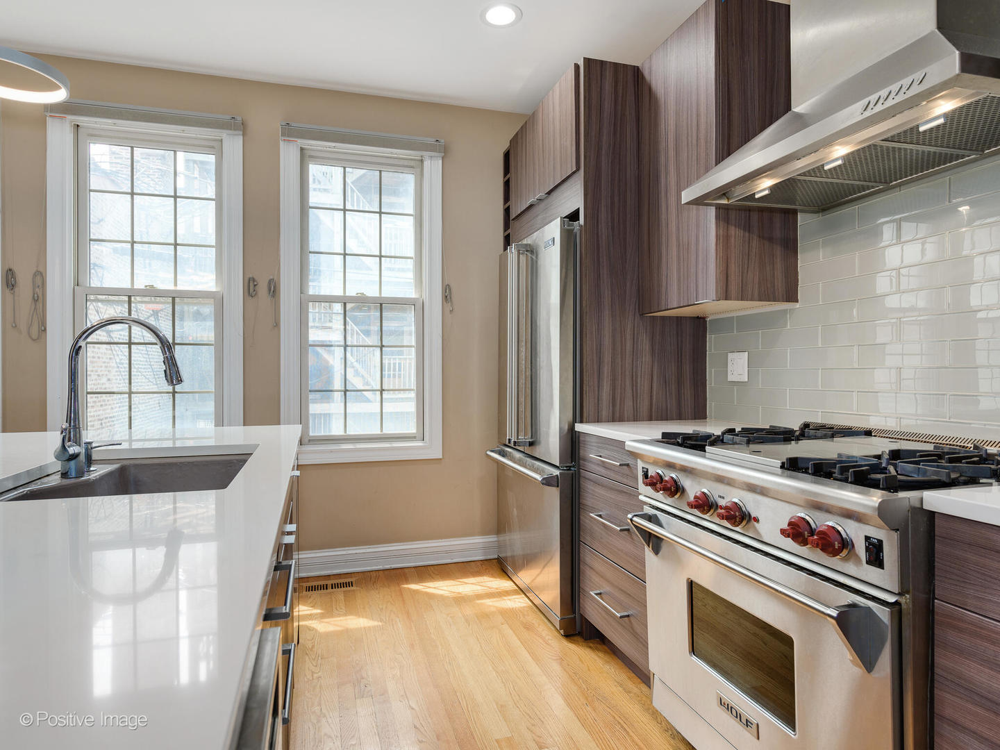 18 North Ada Street, Unit C Chicago, IL 60607 - Photo 8 of 28 a kitchen with a stove a sink and a window
