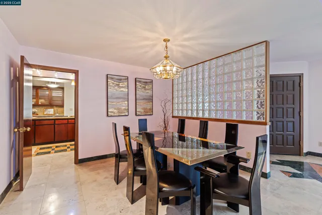 a outdoor dining area with furniture and chandelier