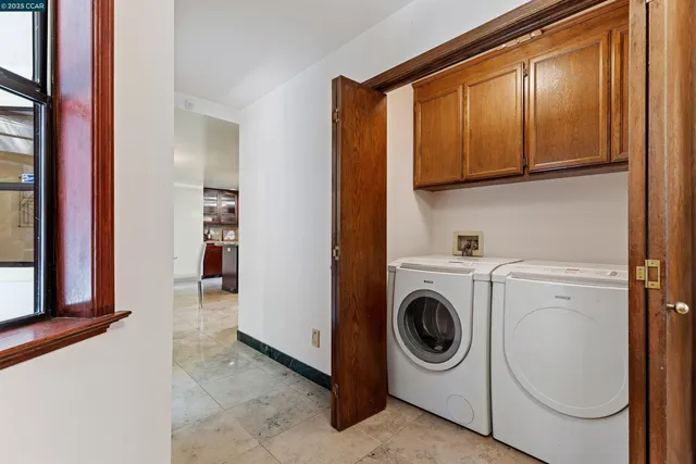 a living room with furniture a bookshelf and a large window