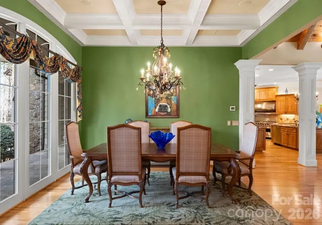a view of a dining room with furniture and chandelier