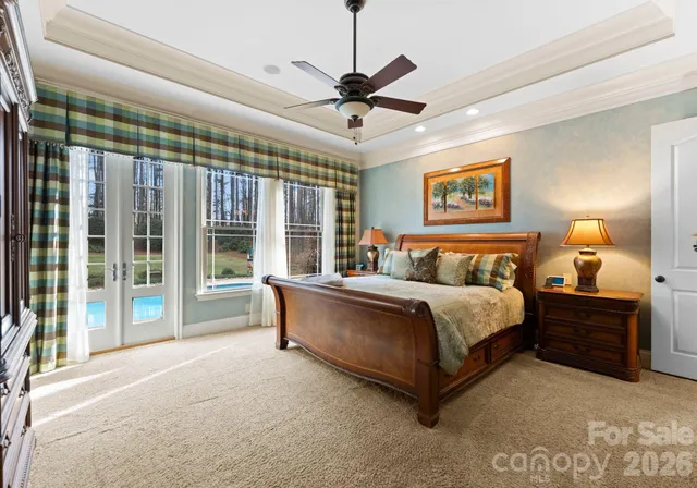 a bed room with a bed and a chandelier