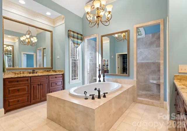 a bathroom with a tub sink and mirror