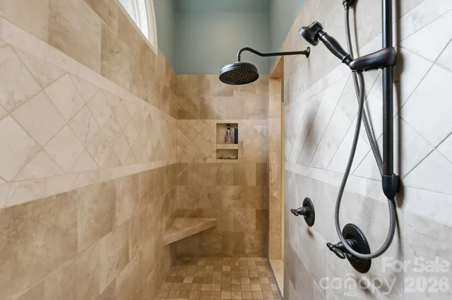 a view of a hallway with wooden floor and windows