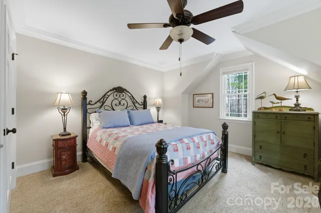 a bedroom with a bed a window and a couch