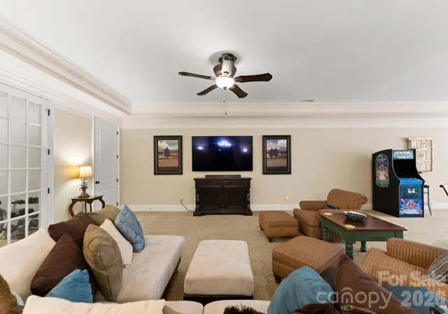 a room with stainless steel appliances lots of wooden furniture and a book shelf