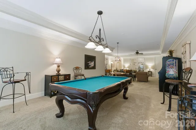 a bedroom with a bed couch and a large window