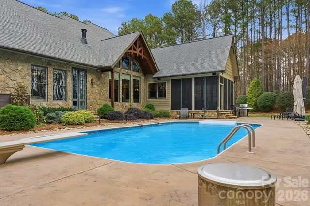 an aerial view of a house with yard swimming pool and outdoor seating