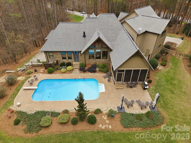 an aerial view of a house with a swimming pool