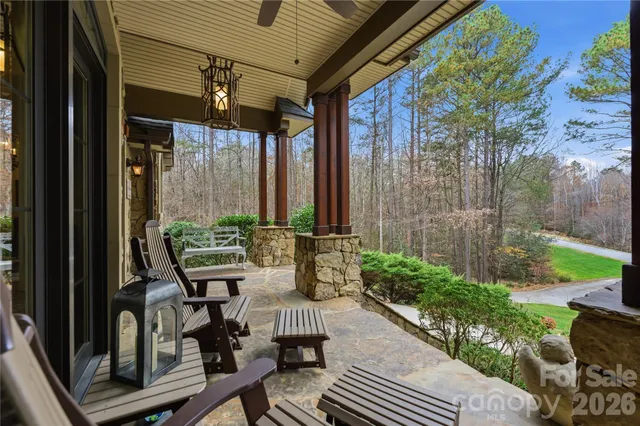 a view of balcony with chairs and potted plants