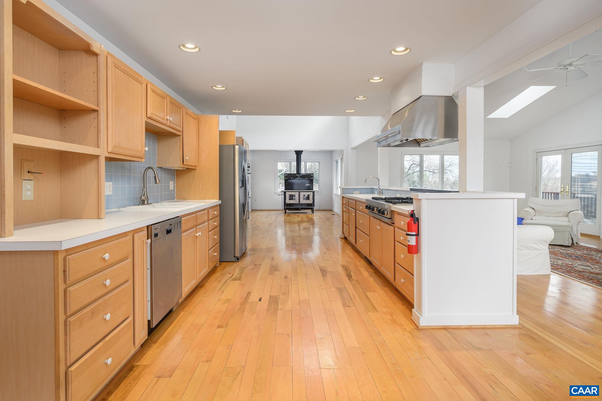 9165 Dick Woods Road Afton, VA 22920 - Photo 11 of 56 a large kitchen with stainless steel appliances lots of counter space and wooden floor